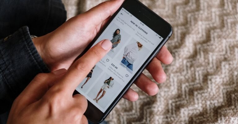 Benefits of Shopping Online at JBF Place Person browsing clothing items on a smartphone, showcasing modern online shopping experience.