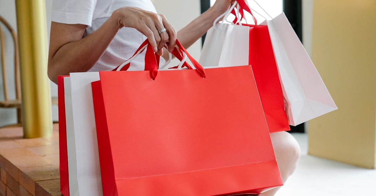 Top Reasons Customers Love Shopping at JBF Place Side view of crop anonymous female buyer in white t shirt sitting on bench with many shopping bags in daylight